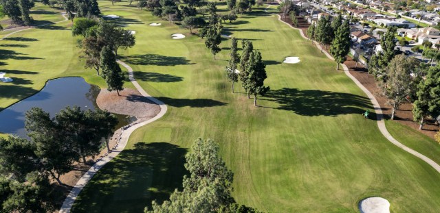 View of golf course with cart path and bunkers